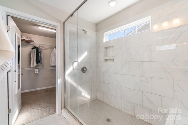 bathroom featuring a shower with door