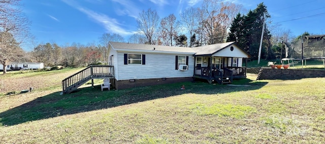 view of front of property featuring cooling unit, a trampoline, a front yard, and a wooden deck