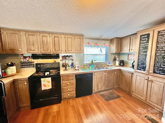 940 Devil Track Rd, Taylorsville, NC 28681 - kitchen featuring black appliances, extractor fan, a sink, light countertops, and a textured ceiling