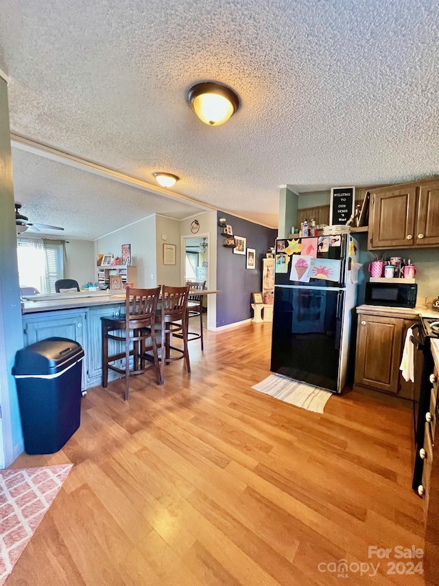940 Devil Track Rd, Taylorsville, NC 28681 - kitchen featuring black appliances, light wood-style floors, light countertops, ceiling fan, and a textured ceiling