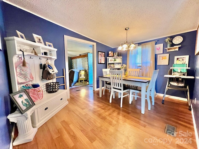 940 Devil Track Rd, Taylorsville, NC 28681 - dining area featuring a textured ceiling, a chandelier, light wood-type flooring, lofted ceiling, and baseboards
