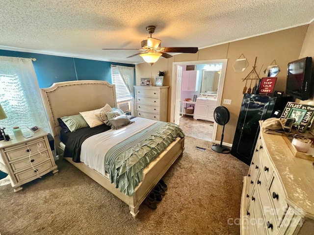 bedroom featuring light carpet, ornamental molding, ensuite bathroom, ceiling fan, and a textured ceiling