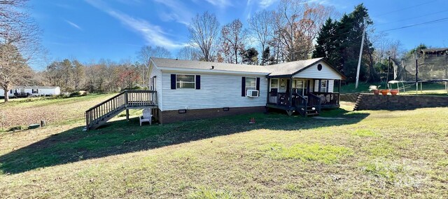 940 Devil Track Rd, Taylorsville, NC 28681 - view of front of home featuring a trampoline, a front yard, crawl space, stairs, and cooling unit