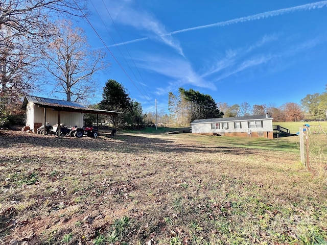 view of yard with an outbuilding and a carport