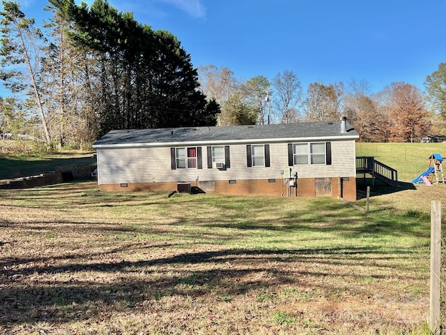 manufactured / mobile home featuring central air condition unit and a front lawn