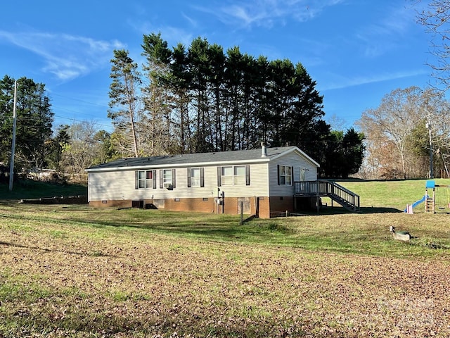 940 Devil Track Rd, Taylorsville, NC 28681 - manufactured / mobile home featuring crawl space, a front yard, a playground, view of scattered trees, and cooling unit