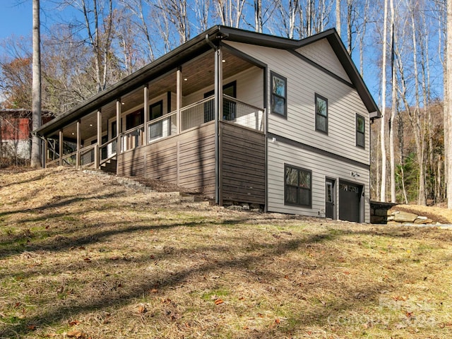 view of side of home featuring a lawn and a garage