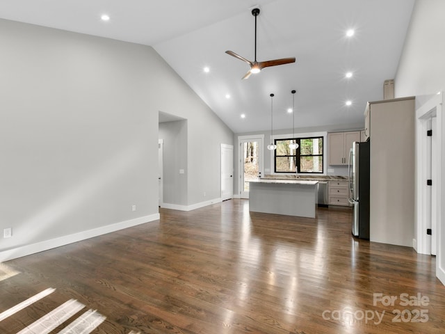 unfurnished living room featuring ceiling fan, high vaulted ceiling, and dark hardwood / wood-style flooring