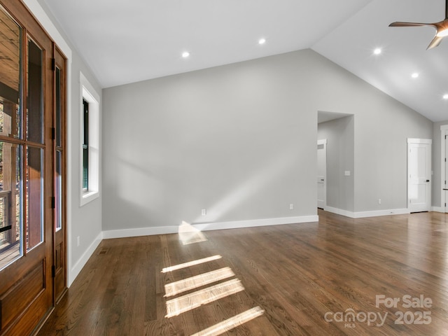 interior space with vaulted ceiling, dark hardwood / wood-style floors, ceiling fan, and plenty of natural light