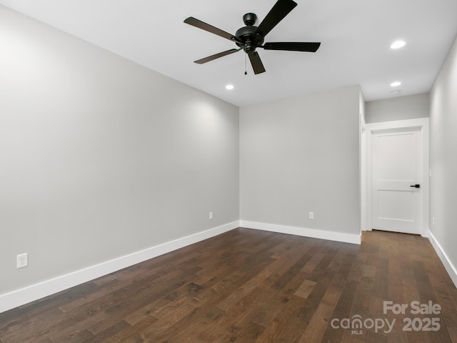 empty room featuring dark wood-type flooring and ceiling fan