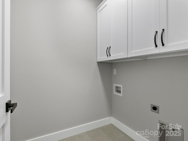 clothes washing area featuring cabinets, hookup for a washing machine, and electric dryer hookup