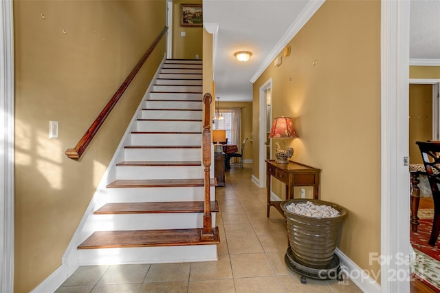 stairway with crown molding and tile patterned flooring