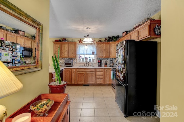 kitchen featuring decorative backsplash, sink, black appliances, light tile patterned floors, and decorative light fixtures