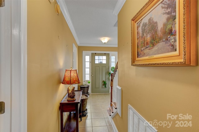 interior space with ornamental molding and light tile patterned floors