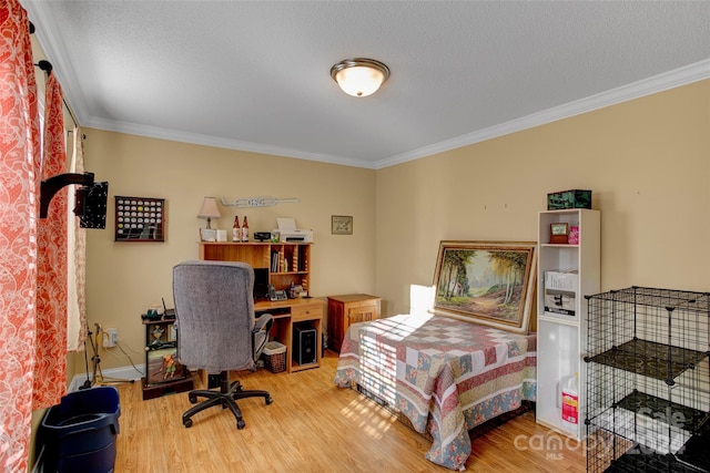 bedroom with crown molding, hardwood / wood-style floors, and a textured ceiling