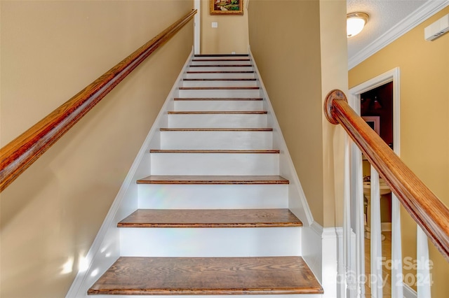 staircase featuring ornamental molding