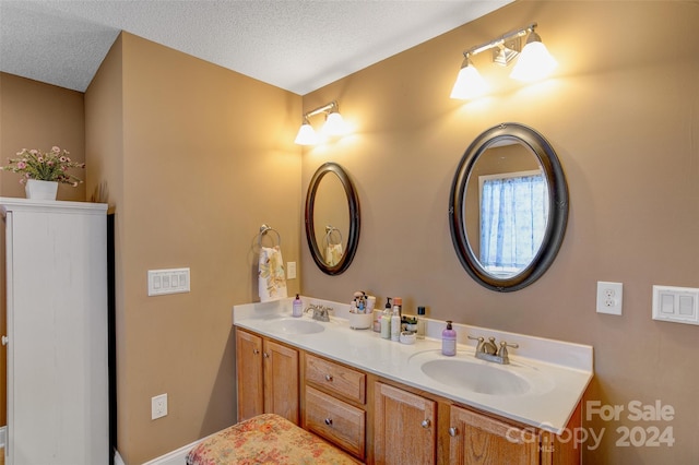 bathroom featuring vanity and a textured ceiling