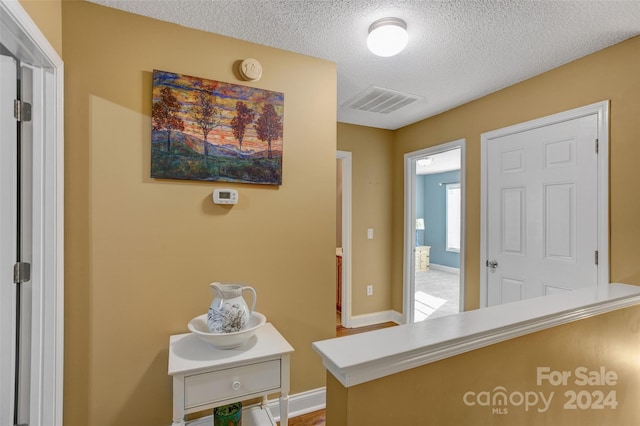 foyer entrance featuring a textured ceiling