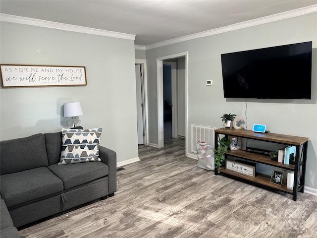 living room featuring ornamental molding and hardwood / wood-style flooring