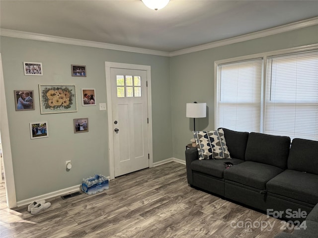 living room with hardwood / wood-style floors and ornamental molding