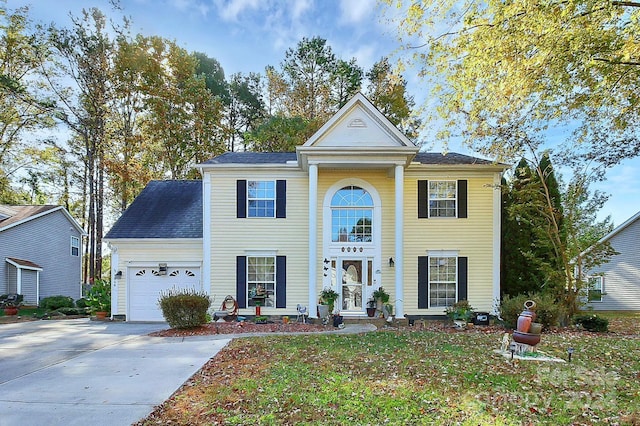 greek revival inspired property with a garage