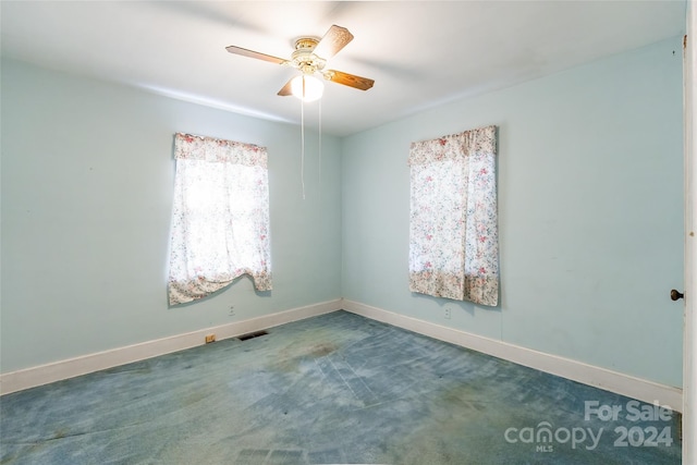 empty room with carpet floors and ceiling fan