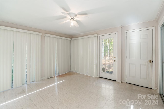 empty room with ceiling fan and ornamental molding