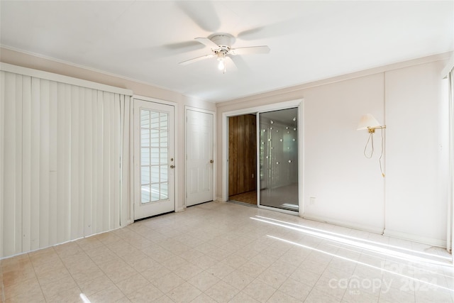 unfurnished room with ceiling fan and crown molding