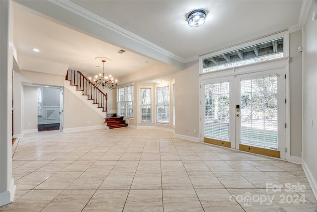 interior space featuring light tile patterned flooring, french doors, crown molding, and an inviting chandelier