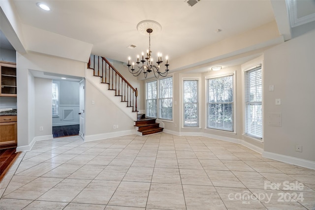 interior space featuring light tile patterned floors and a notable chandelier