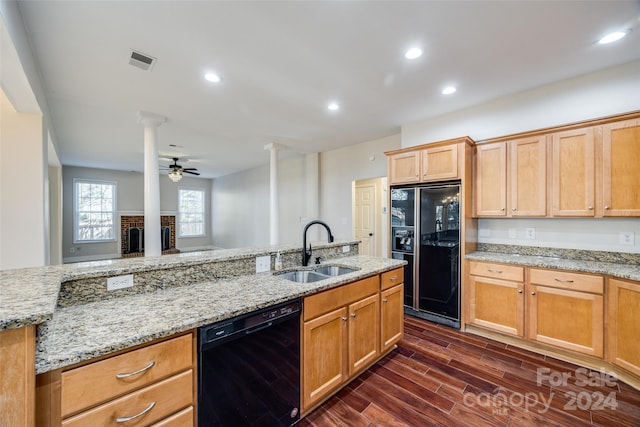 kitchen with black appliances, sink, ceiling fan, dark hardwood / wood-style floors, and ornate columns