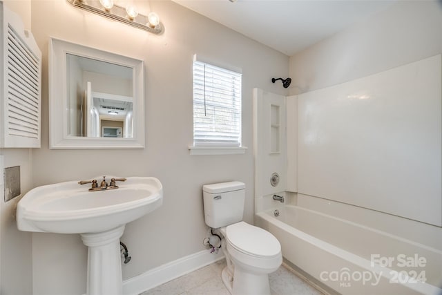 bathroom featuring tile patterned floors, bathing tub / shower combination, and toilet