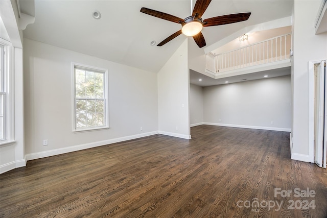 unfurnished living room featuring dark hardwood / wood-style flooring, high vaulted ceiling, and ceiling fan