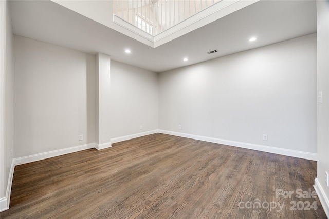 unfurnished room with dark hardwood / wood-style floors