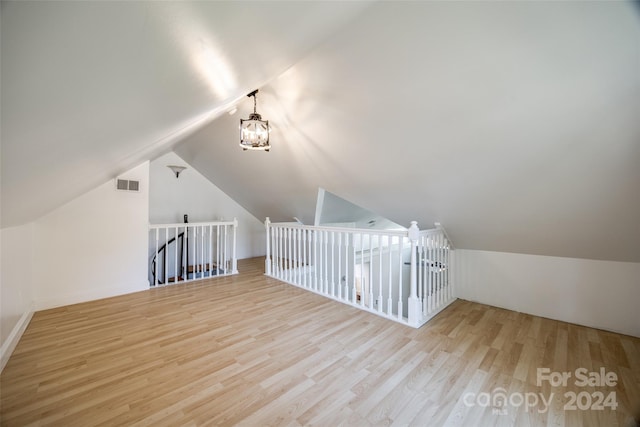 bonus room with light hardwood / wood-style floors and lofted ceiling