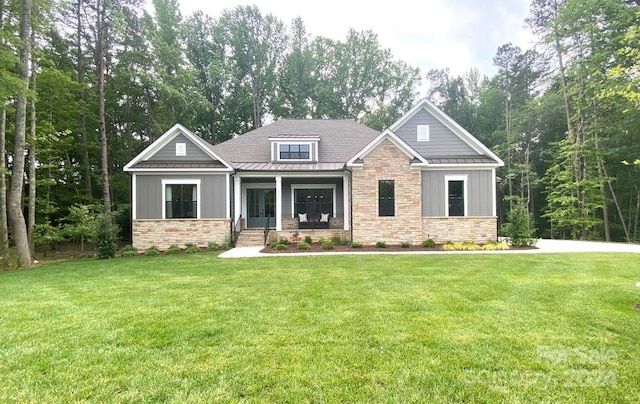 craftsman-style home featuring covered porch and a front lawn