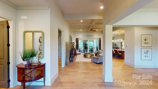 corridor with beamed ceiling, ornamental molding, light hardwood / wood-style flooring, and coffered ceiling