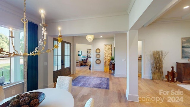 dining area featuring crown molding, french doors, and light hardwood / wood-style flooring