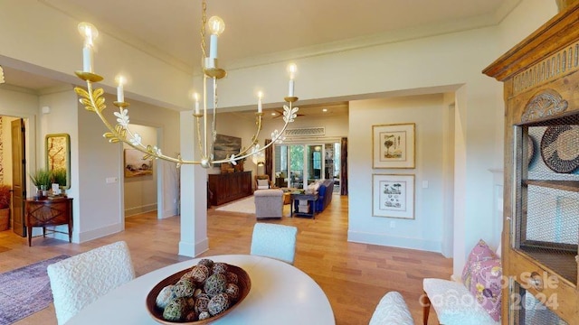 dining area with hardwood / wood-style floors and ornamental molding