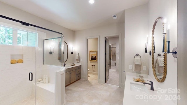 bathroom with vanity, toilet, and an enclosed shower