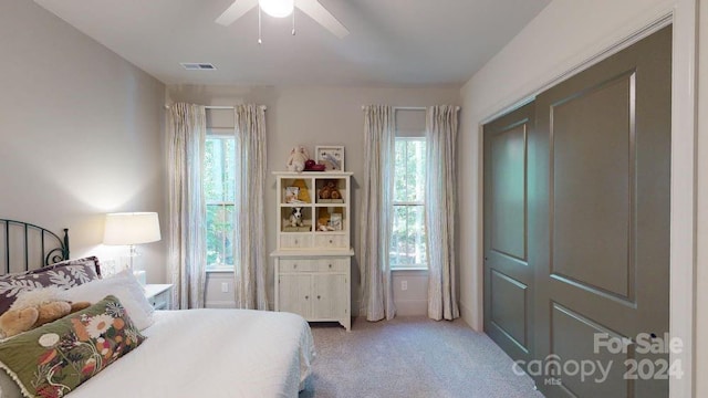 bedroom with carpet, a closet, and ceiling fan