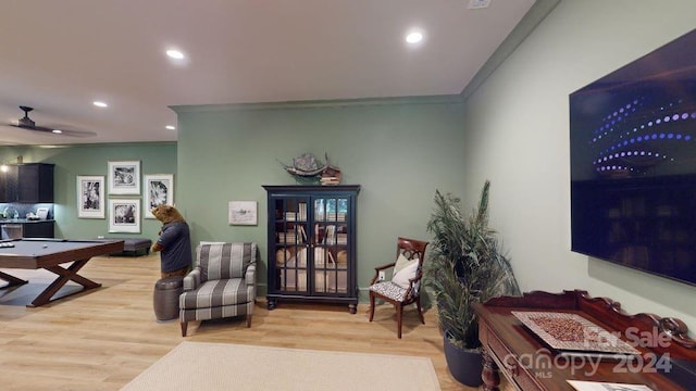 interior space featuring wood-type flooring, ceiling fan, ornamental molding, and pool table