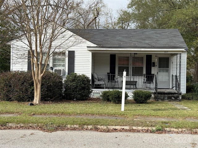 bungalow with a front yard and a porch