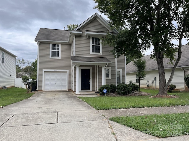 view of front property featuring a front lawn and a garage