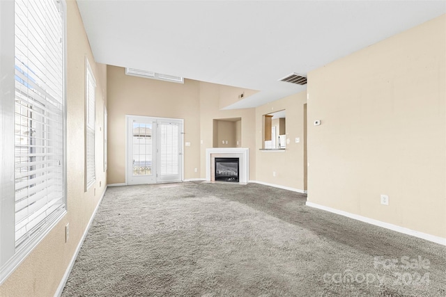 unfurnished living room featuring carpet