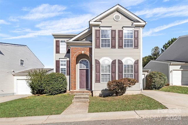 view of front facade with a garage and a front lawn