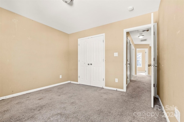 unfurnished bedroom with carpet flooring and a closet