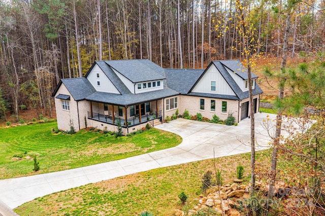 view of front of property featuring covered porch and a front yard