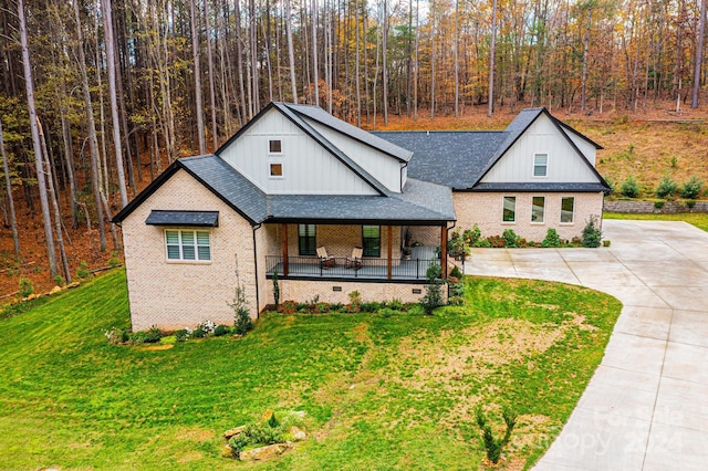 modern inspired farmhouse with a porch and a front lawn