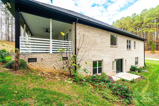 rear view of property with ceiling fan